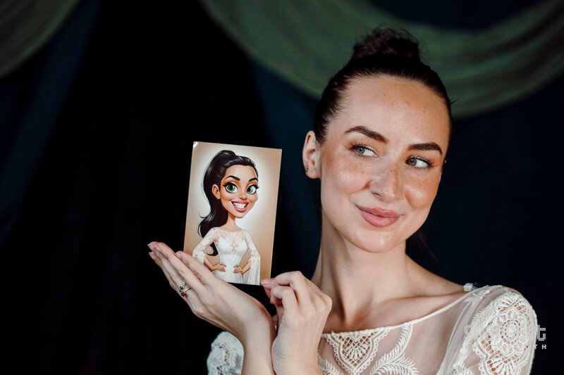Caricature Wedding C9AKFP 005 a woman holding a caricature print of herself