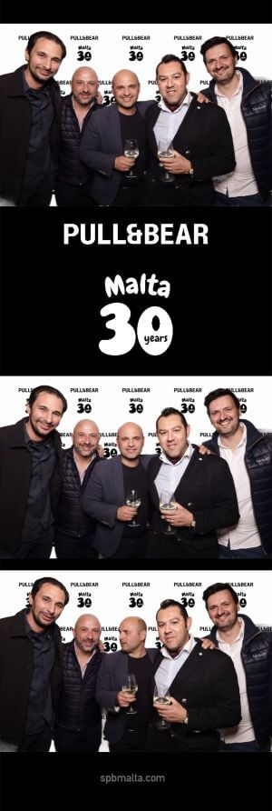 pull-and-bear-malta-30th-anniversary-guests-photo-strip Photo strip of four men posing together at the event, holding drinks and smiling in front of branded backdrop.