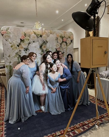 Arrigo-wedding-woman woman taking pictures in front of the booth