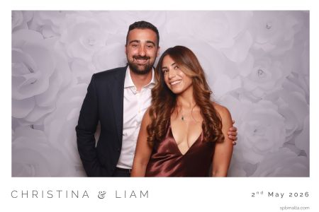 wedding-guest-couples-photo-booth-malta A couple posing for a timeless 6x4 postcard-style photo at a Maltese wedding reception.