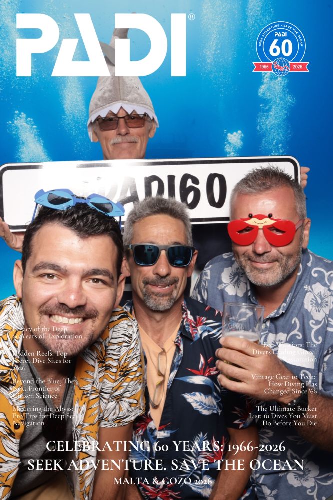 padi-dive-community-photo-booth A cheerful group of divers and guests gathering in front of a photo booth to take a picture together at a PADI event.
