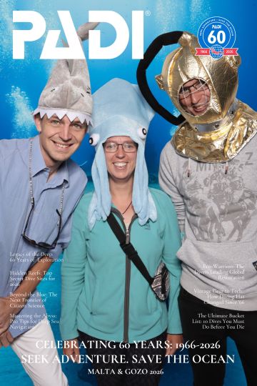 padi-event-photo-booth-guests-07 Another group of PADI event guests smiling for a photo at the event backdrop.