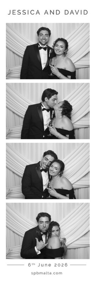 jessica & david-05 A couple posing in front of a photo booth backdrop for a black and white wedding photo strip.