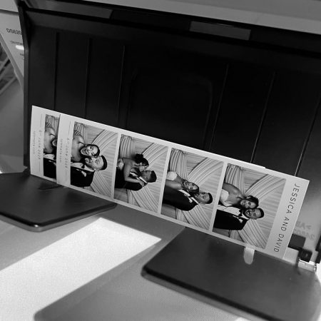 wedding-photo-booth-malta-photo-strip-printing Custom black and white photo strips of the bride and groom printing instantly at a high-energy Phoenicia Hotel Malta wedding reception.