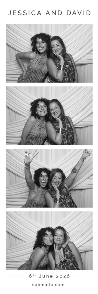 wedding-photo-booth-malta-two-women-photo-strip Friends posing in front of a photo booth backdrop for a black and white wedding photo strip.