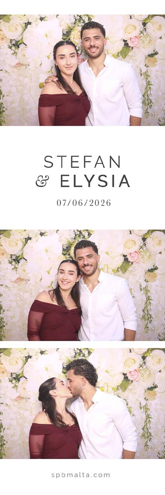 wedding-photo-booth-malta-couple-photo-strip-1 A couple smiling and hugging in front of a white and pink floral wedding backdrop.