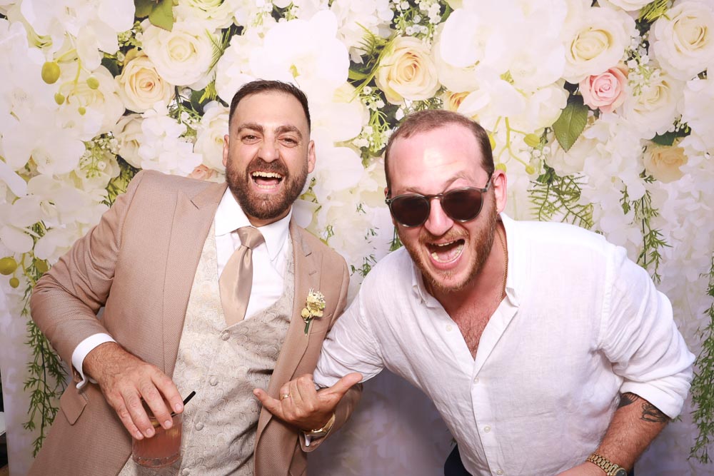 wedding-photo-booth-malta-groom-and-friend Groom posing with a friend and capturing a fun wedding photo booth moment together.